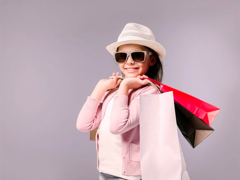 A smiling shopper holding shopping bags